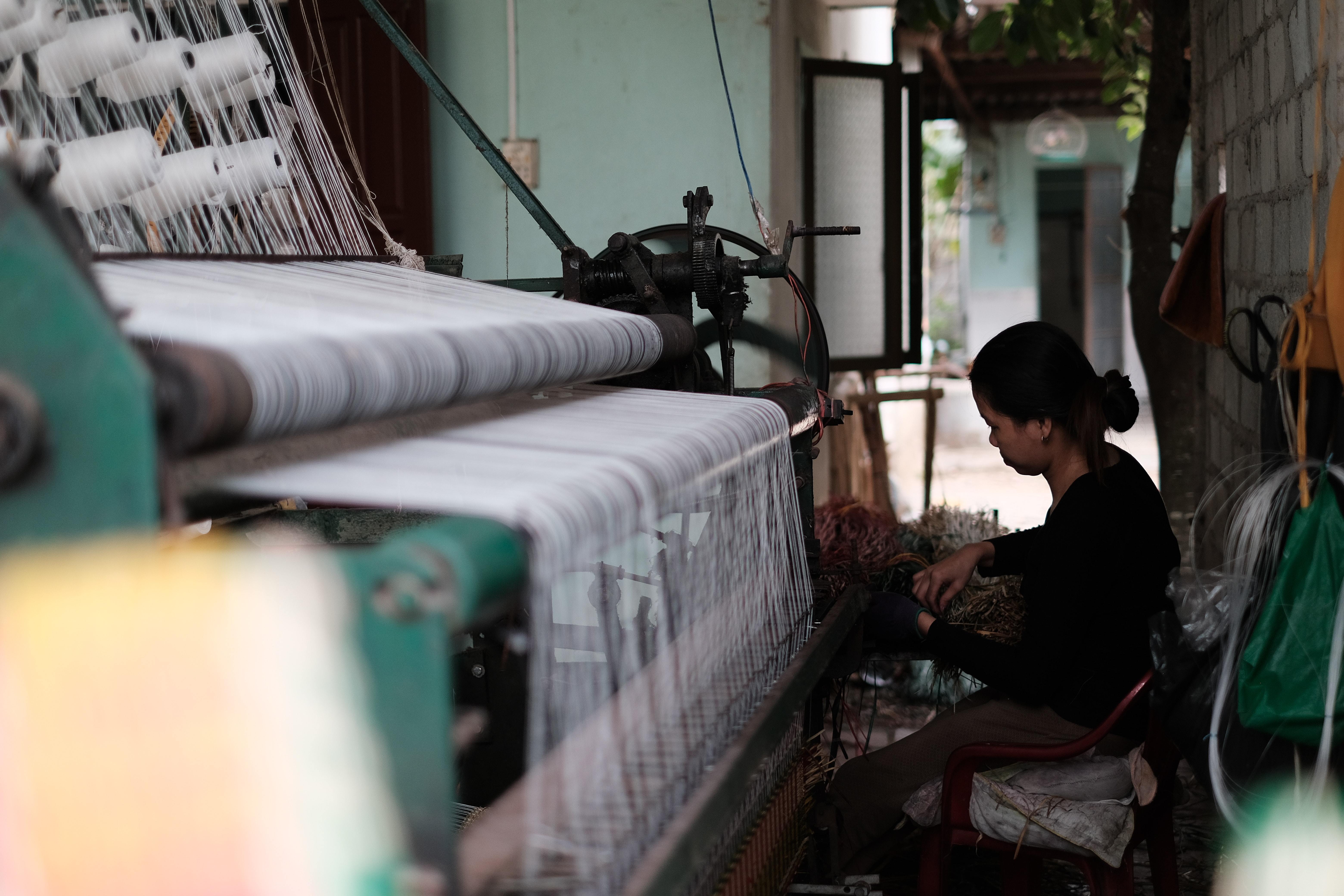 Woman working on a textile machine 2892373